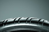 Tires showing for sell or fix in the shop. Tire repair concept. Closeup of damaged car tire. Car wheel in auto repair shop.