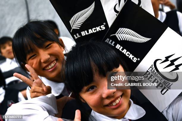 Local children pose at an All Blacks fan event with New Zealand's players in Beppu on October 1 during the Japan 2019 Rugby World Cup.