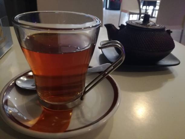 having a cup of tea - babeltee stock pictures, royalty-free photos & images