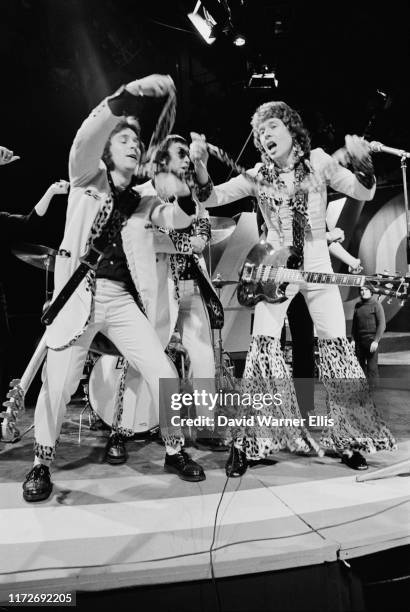 British glam rock band Mud performing on the television music show 'Top Of The Pops', circa 1974. From left to right, bass player Ray Stiles, singer...