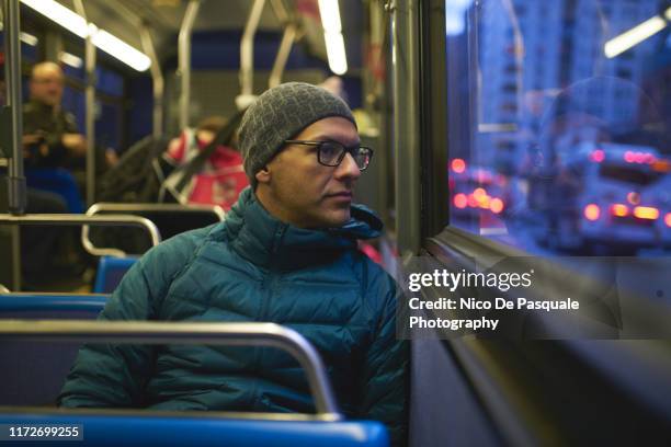 man looking through bus window - bus interior stock-fotos und bilder