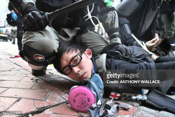 Protester is detained by police as violent demonstrations take place in the streets of Hong Kong on October 1 as the city observes the National Day...