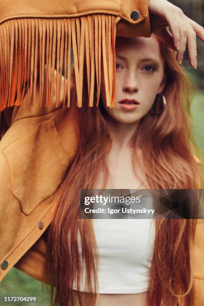 young girl wearing fringed suede jacket - quaste stock-fotos und bilder