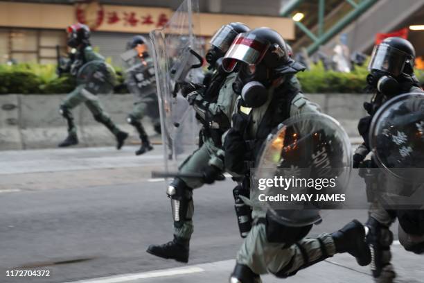 Hong Kong police advance on protesters during a demonstration in the Sham Shui Po area in Hong Kong on October 1 as the city observes the National...