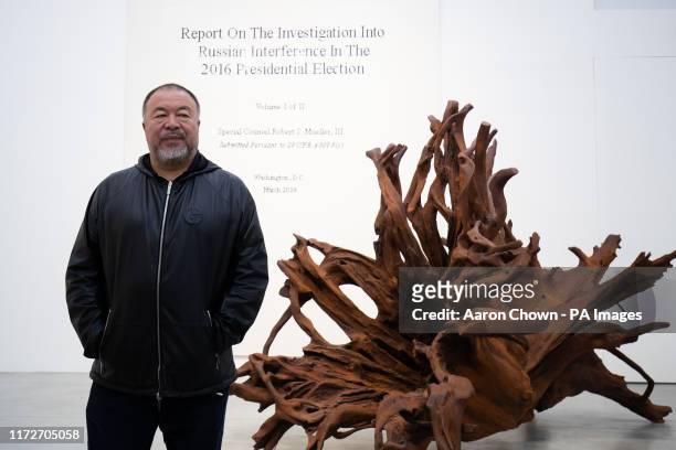 Chinese artist Ai Weiwei stand in in front of 'Martin 2019' and 'The Cover Page of The Mueller Report, Submitted to Attorney General William Barr by...