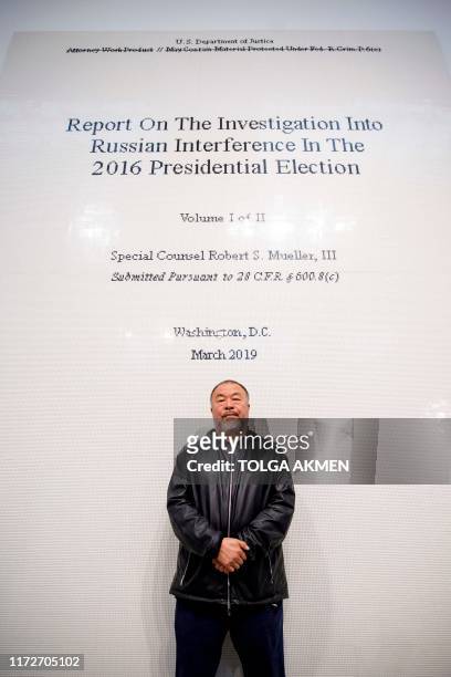 Chinese artist Ai Weiwei poses with his artwork made of lego entitled "The Cover Page of The Muller Report, Submitted to Attorney General William...
