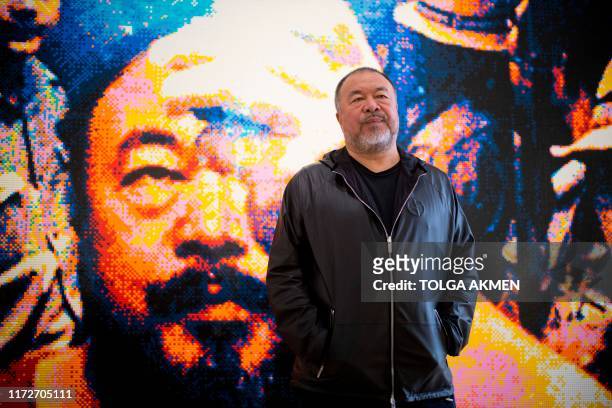 Chinese artist Ai Weiwei poses with his artwork made of Lego, entitled "Illumination 2019" during a photocall to promote his exhibition 'Roots' at...