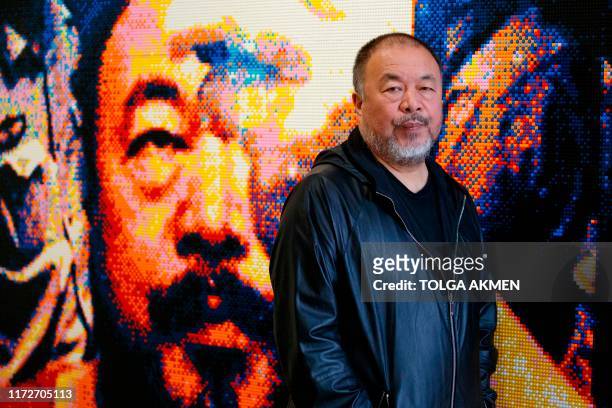 Chinese artist Ai Weiwei poses with his artwork made of Lego, entitled "Illumination 2019" during a photocall to promote his exhibition 'Roots' at...