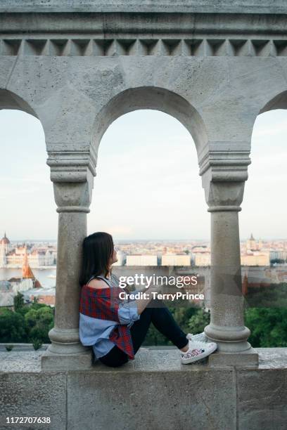 a tourist take a causal walk on a famous sightseeing spot - fishermen's bastion, halászbástya. - fishermen's bastion stock pictures, royalty-free photos & images