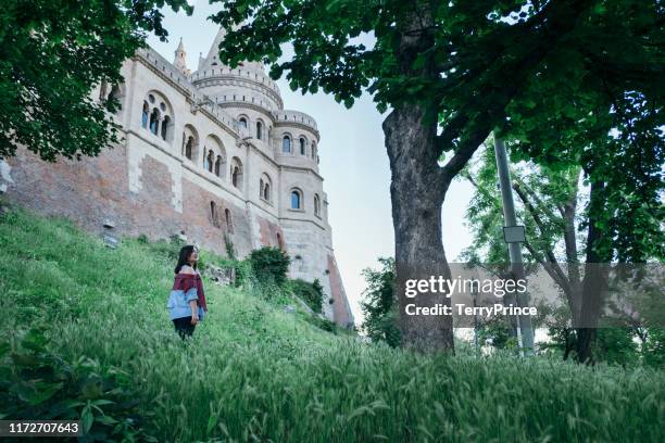 a tourist take a causal walk on a famous sightseeing spot - fishermen's bastion, halászbástya. - fishermen's bastion stock pictures, royalty-free photos & images