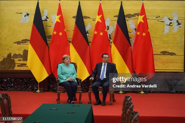 Chinese Premier Li Keqiang and Chancellor of Germany Angela Merkel sit before the signing ceremony during the meeting at The Great Hall Of The People...