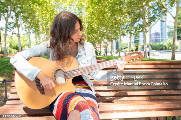 woman playing her acoustic guitar - flamencos stock-fotos und bilder