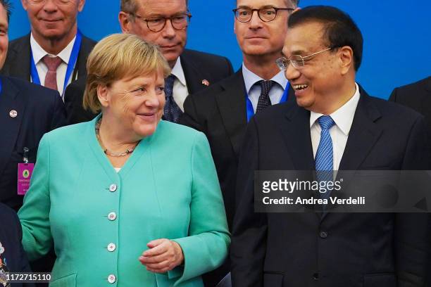 Chinese Premier Li Keqiang , Chancellor of Germany Angela Merkel and other attendees prepare to take a group photo after the Round Table of the...