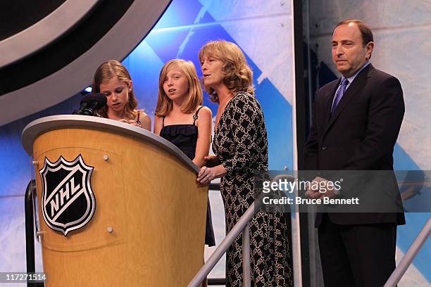 Daughters Jacqueline and Erin McGuire and mother Terry McGuire speak as NHL Commissioner Gary Bettman looks on during day one of the 2011 NHL Entry...