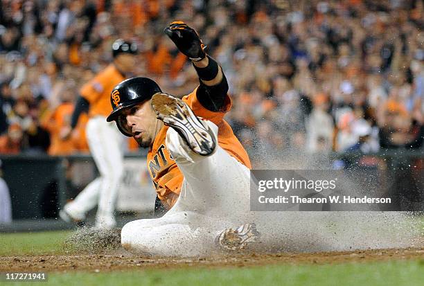 Andres Torres of the San Francisco Giants scores on a foul pop-out by Aubrey Huff against the Cleveland Indians in the bottom of the six inning...