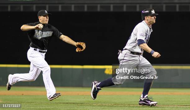 Brendan Ryan of the Seattle Mariners is run down by third baseman Greg Dobbs of the Florida Marlins in the seventh inning at Safeco Field on June 24,...