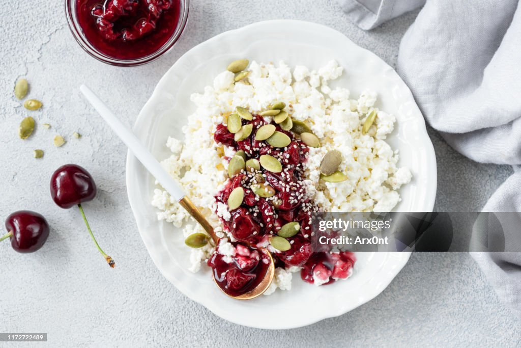 Cottage cheese with cherry jam on plate