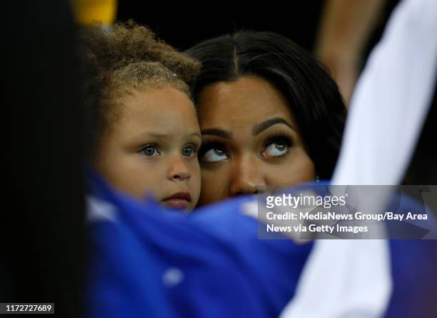Riley Curry and her mom Ayesha, daughter and wife respectively, of Golden State Warriors' Stephen Curry watch Curry during warmups against the...