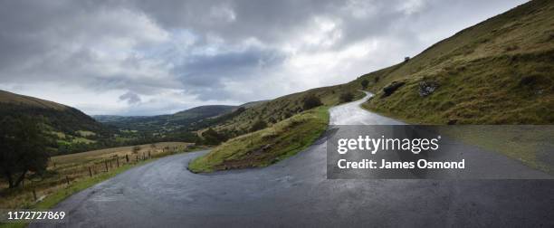 hairpin bend on steep road. wet tarmac after rain shower. - steep road stock pictures, royalty-free photos & images