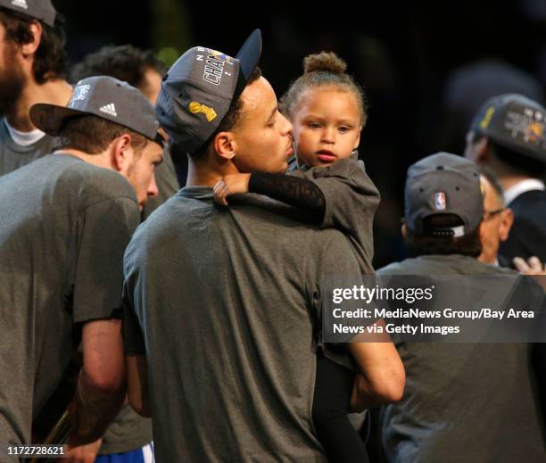 Golden State Warriors' Stephen Curry gives his daughter Riley a kiss after the Golden State Warriors 105-97 win over the Cleveland Cavaliers in Game...