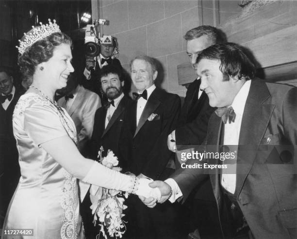 English comedian Les Dawson shakes hands with Queen Elizabeth II at the Royal Variety Performance at the Theatre Royal, Drury Lane, 10th November...