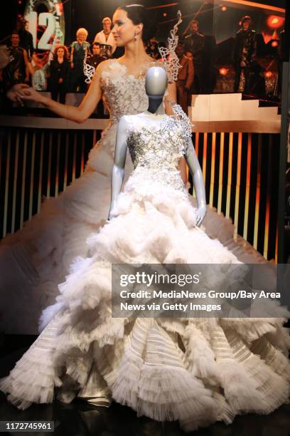 Wedding dress costume from the movie "The Hunger Games: Catching Fire" is photographed during a media tour of "The Hunger Games Exhibition" at the...