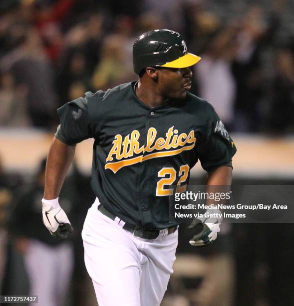 Oakland Athletics' Chris Carter watches as his three run walk-off home run ball off of Seattle Mariners pitcher Steve Delabar sails over the left...