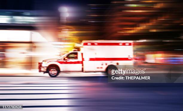 ambulance speeding at night in new york city - new flash stock pictures, royalty-free photos & images