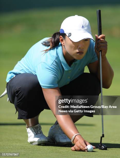 Golfer Amy Yang sets her ball before putting on the 9th hole during the third round of the CVS/pharmacy LPGA Challenge on Saturday, Sept. 26, 2009 at...