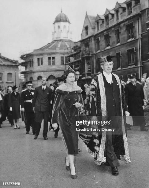 Queen Elizabeth II visits British Prime Minister Harold Macmillan , Chancellor of Oxford University, in Oxford, 4th November 1960. They are walking...