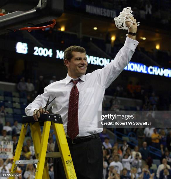 University of Connecticut women's basketball coach Geno Auriemma cuts down the nets after his team defeated Tennessee to win the 2004 NCAA National...
