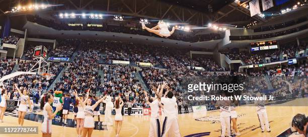 Panoramic view of cheerleaders as they perform during a sold out Big East basketball game between the University of Connecticut and the University of...