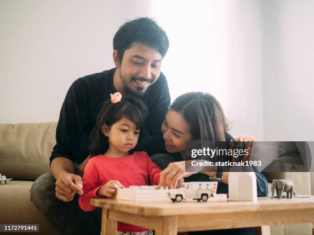 cheerful family playing wood toy. - game night leisure activity stock pictures, royalty-free photos & images