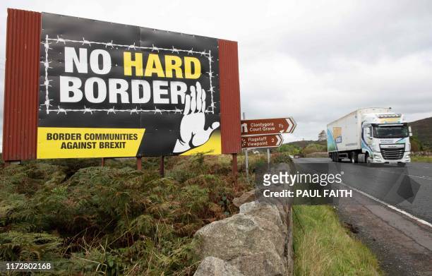 Vechile passes an anti-Brexit pro-Irish unity billboard seen from the Dublin road in Newry, Northern Ireland, on October 1, 2019 on the border...