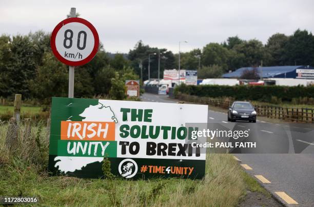 Traffic passes an anti-Brexit pro-Irish unity billboard seen from the Dublin road in Newry, Northern Ireland, on October 1, 2019 on the border...