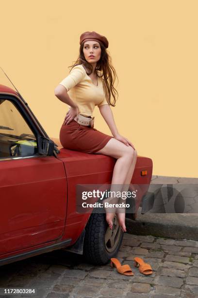 Young beautiful girl dressed in retro vintage style in the old european city