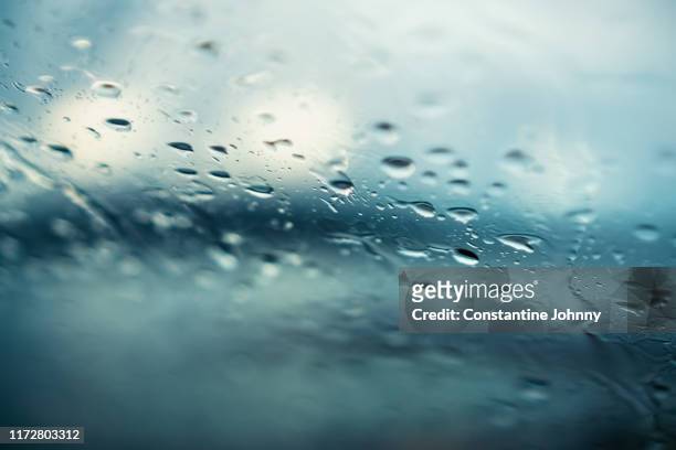 water drops on car windshield on gloomy day - mirror steam fotografías e imágenes de stock