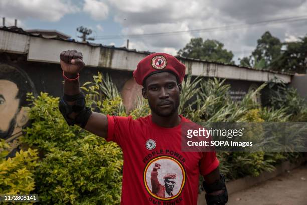 Supporter of Robert Kyagulanyi aka Bobi Wine makes a gesture during the press conference in Kampala. Uganda's military announced that red berets had...