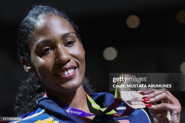 Bronze medallist USA's Ajee Wilson poses on the podium during the medal ceremony for the Women's 800m at the 2019 IAAF World Athletics Championships...