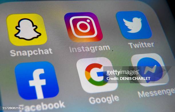 Picture taken on October 1, 2019 in Lille shows the logo of mobile app Instagram, Snapchat, Twitter, Facebook, Google and Messenger are displayed on...