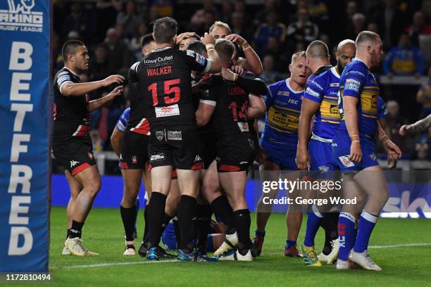 Joey Lussick of Salford Red Devils celebrates with his team mates after scoring a try during the Betfred Super League match between Leeds Rhinos and...