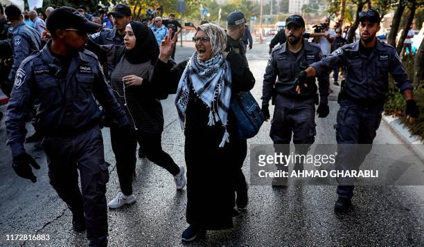 Palestinian women, surrounded by Israeli security forces, chant slogans during a demonstration near the Hadassah Medical Center Mount Scopus in...