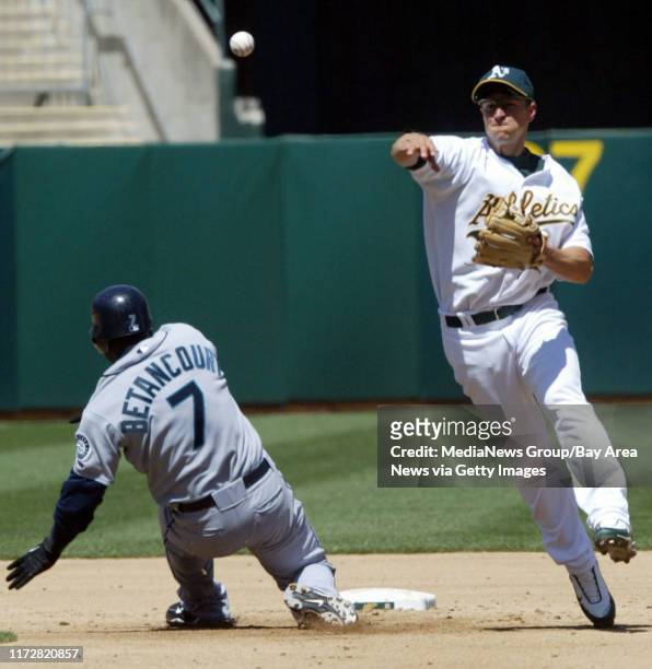 Oakland Athleticsø Mark Ellis gets the force out against Seattle Mariners Yuniesky Betancourt at second but fails to throw out Mariners Franklin...