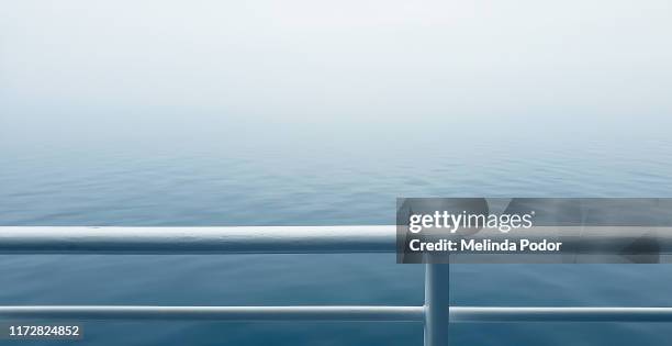 foggy ocean from the deck of a ship - railing stockfoto's en -beelden