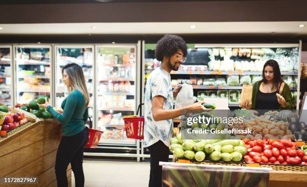 people shopping in the supermarket - produce aisle stock pictures, royalty-free photos & images