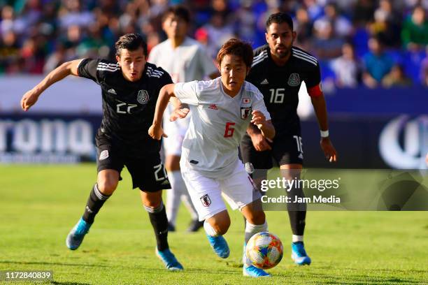 Alan Mozo of Mexico fights for the ball with Ao Tanaka of Japan during a friendly match between Mexico and Japan at Miguel Aleman Valdes Stadium on...