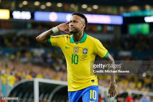 Neymar Jr. #10 of Brazil reacts after assisting Casemiro on a goal against Colombia during the first half of the friendly at Hard Rock Stadium on...