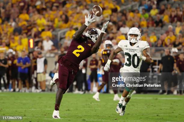 Wide receiver Brandon Aiyuk of the Arizona State Sun Devils catches a 52 yard reception ahead of defensive back Allen Perryman of the Sacramento...
