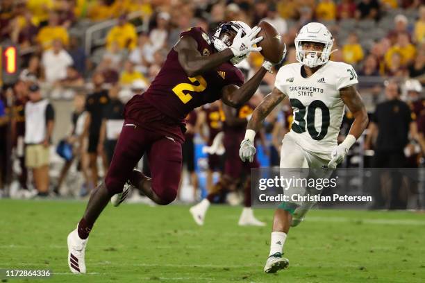 Wide receiver Brandon Aiyuk of the Arizona State Sun Devils catches a 52 yard reception ahead of defensive back Allen Perryman of the Sacramento...