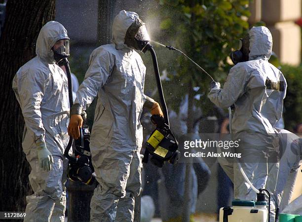 Hazardous materials worker sprays his colleagues October 23, 2001 after they came out from a anthrax search at the Longworth House Office Building on...